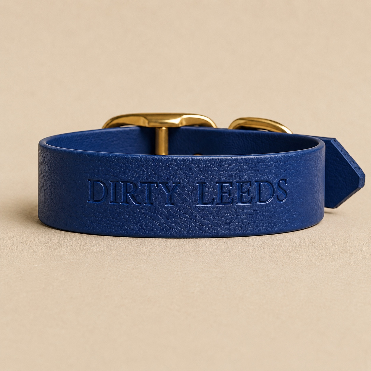 Reverse view of the Dirty Leeds® navy dog collar showing the embossed DIRTY LEEDS lettering.