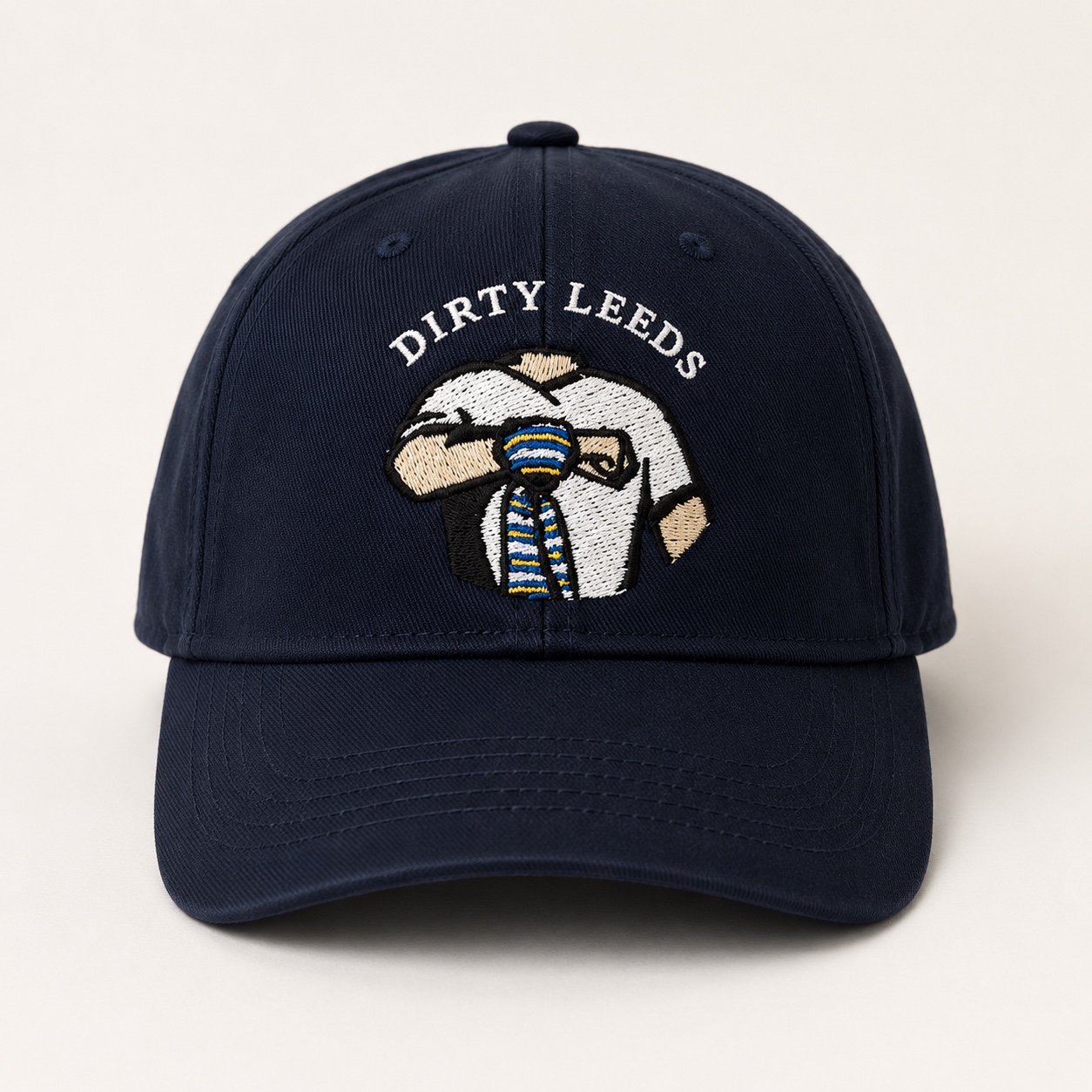 Front view of the navy Dirty Leeds® Original Keep Fighting Salute Logo Baseball Cap with embroidered front logo and curved peak.