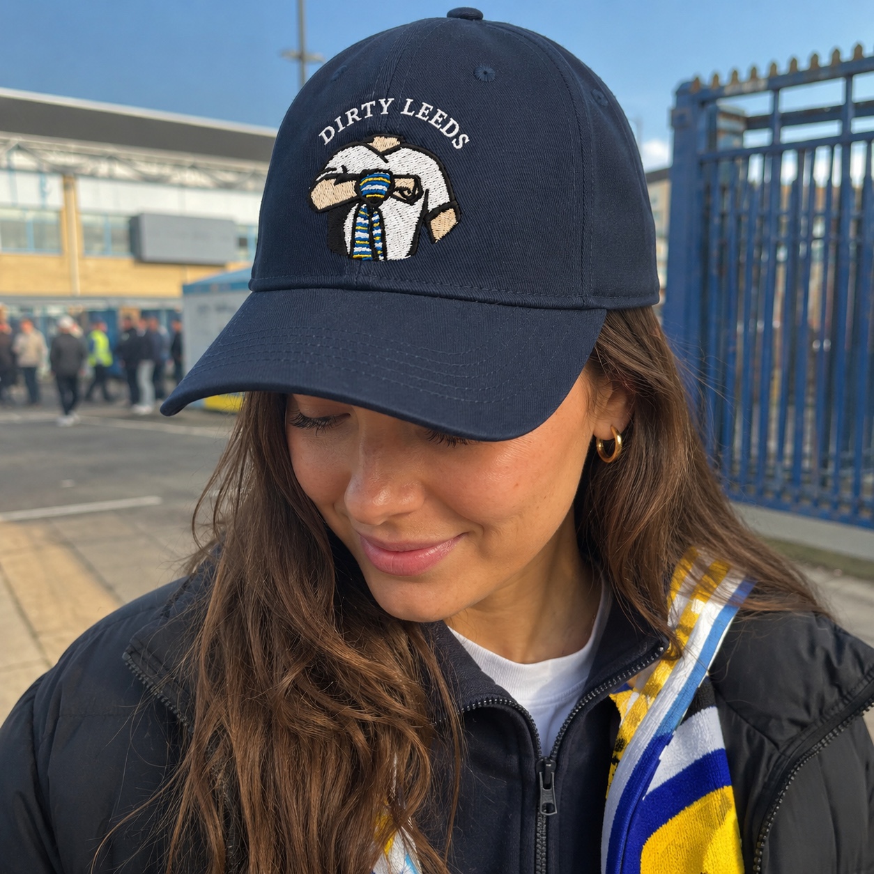 Dirty Leeds® Original Keep Fighting Salute Logo Navy Baseball Cap – lifestyle image with supporter.