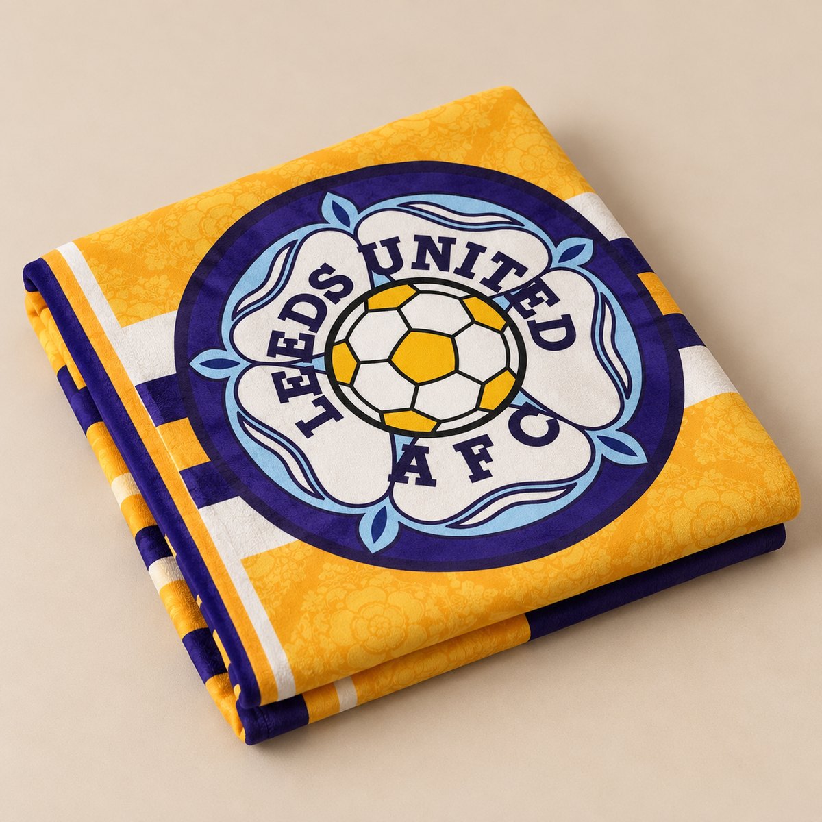 Dirty Leeds® XL Luxury Leeds United beach towel folded to show the Leeds United AFC badge.