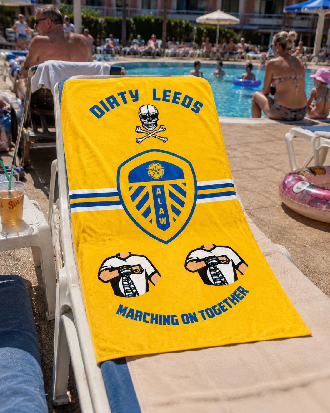 Yellow Dirty Leeds® Beach Towel – shown on a sunbed.
